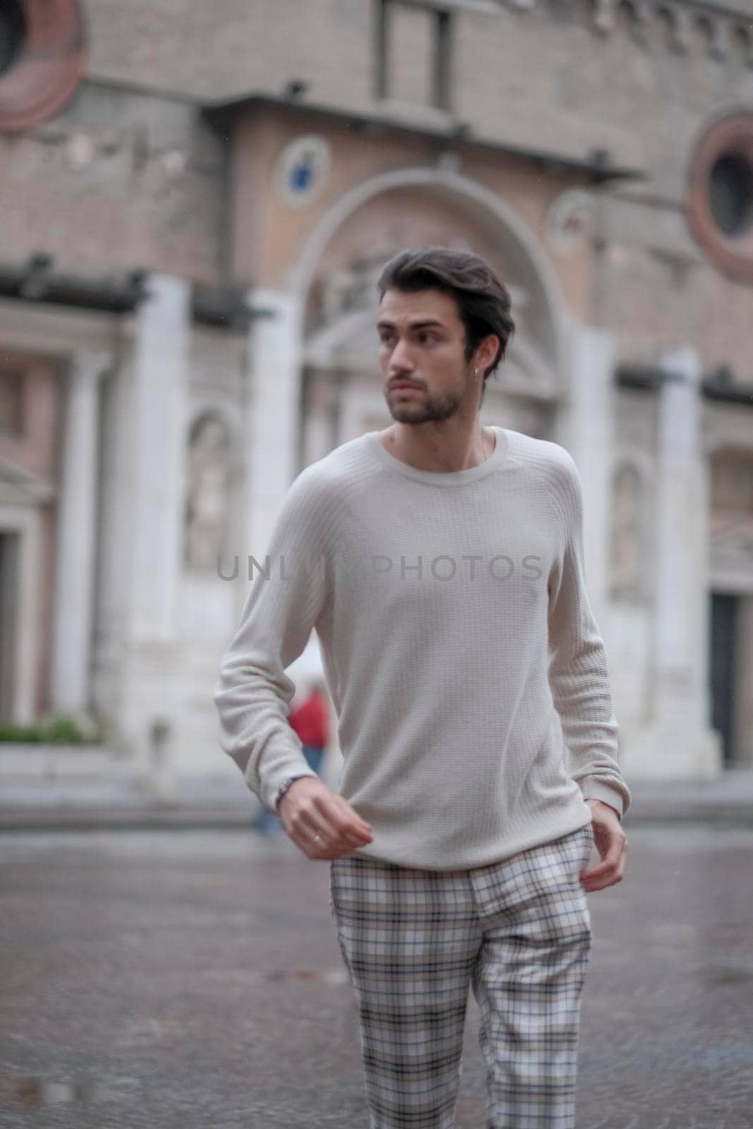 beautiful guy with white sweater in the center of reggio emilia by tinofotografie