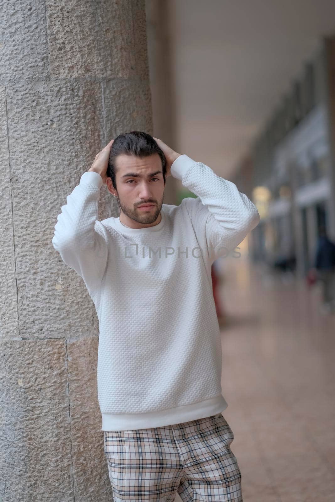 beautiful guy with white sweater in the center of reggio emilia by tinofotografie