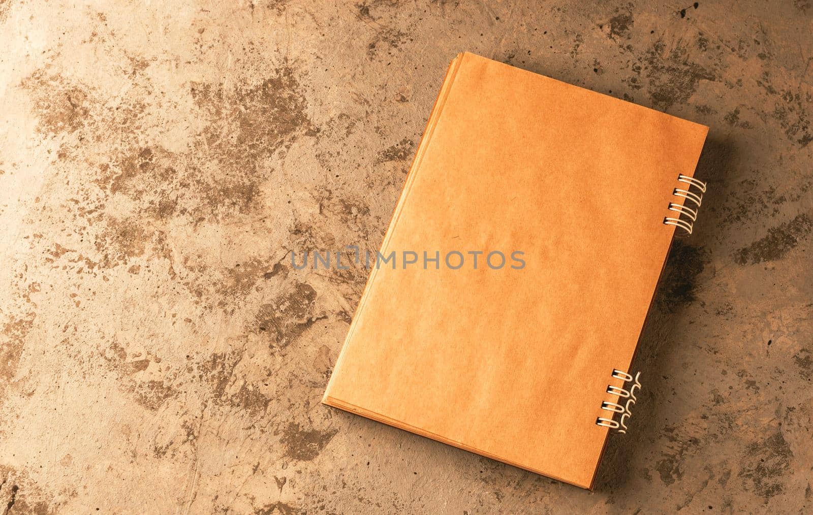 copybook lies on the table in open form. Layout for writing text. Spiral notebook in craft paper. Top view. Business concept.