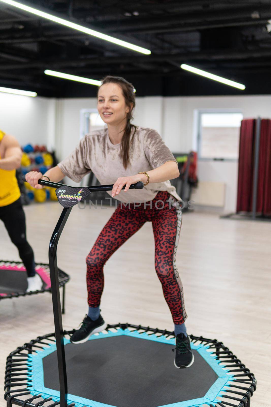 Women's and men's group on a sports trampoline, fitness training, healthy life - a concept trampoline group batut workout healthy, In the afternoon lifestyle activity from fitness from exercise shaping, sportive beautiful. Studio beauty athlete, aerobic