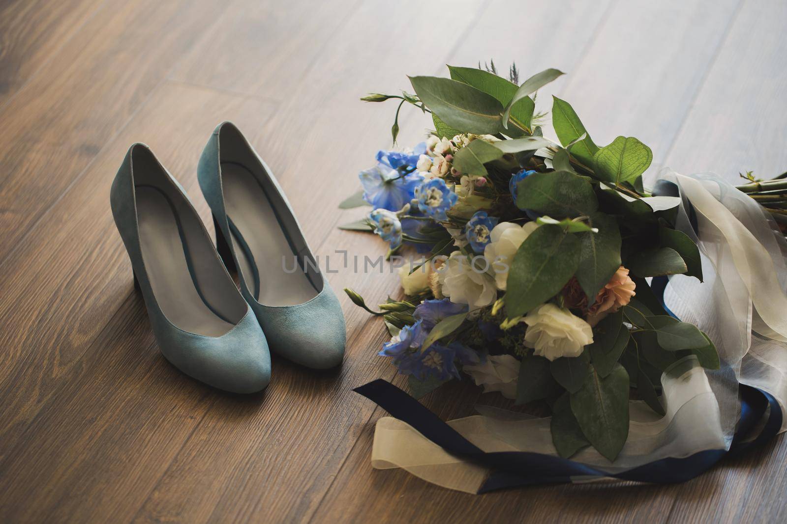 Wedding bouquet and the bride's shoes on the floor. by StudioPeace