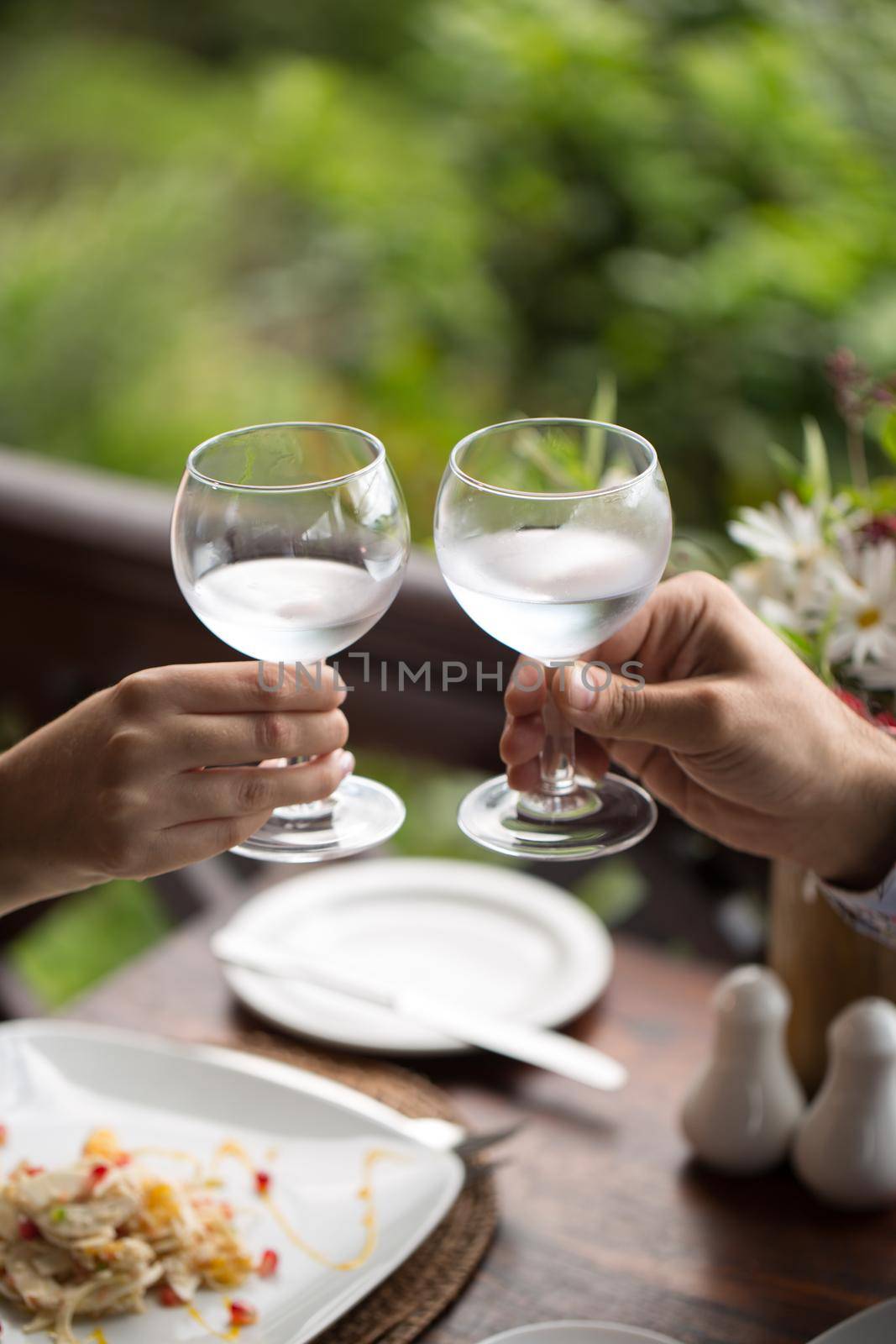 bride and groom holding beautifully decorated wedding glasses