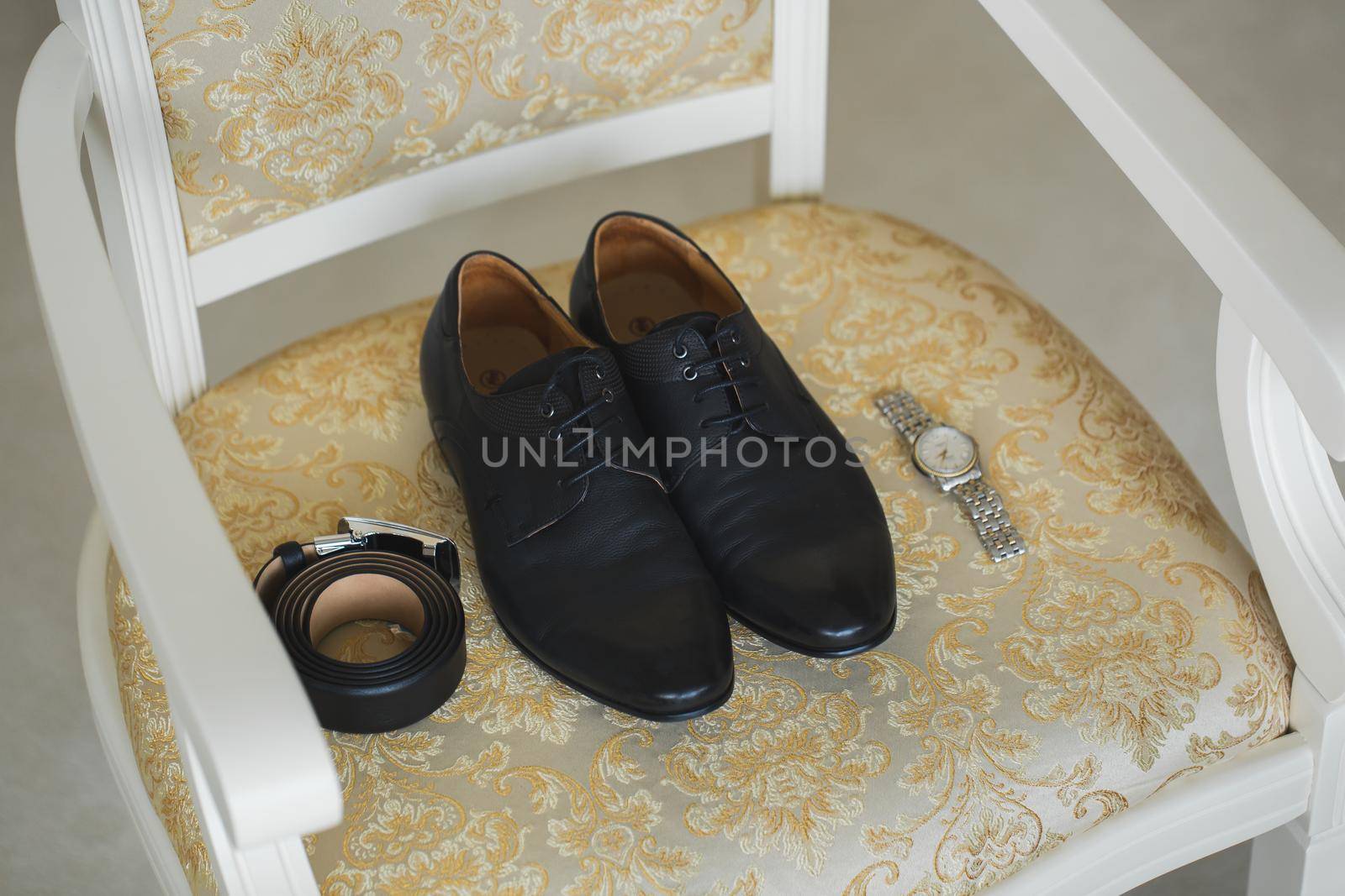 Accessories for the groom. Wedding shoes on a chair. by StudioPeace