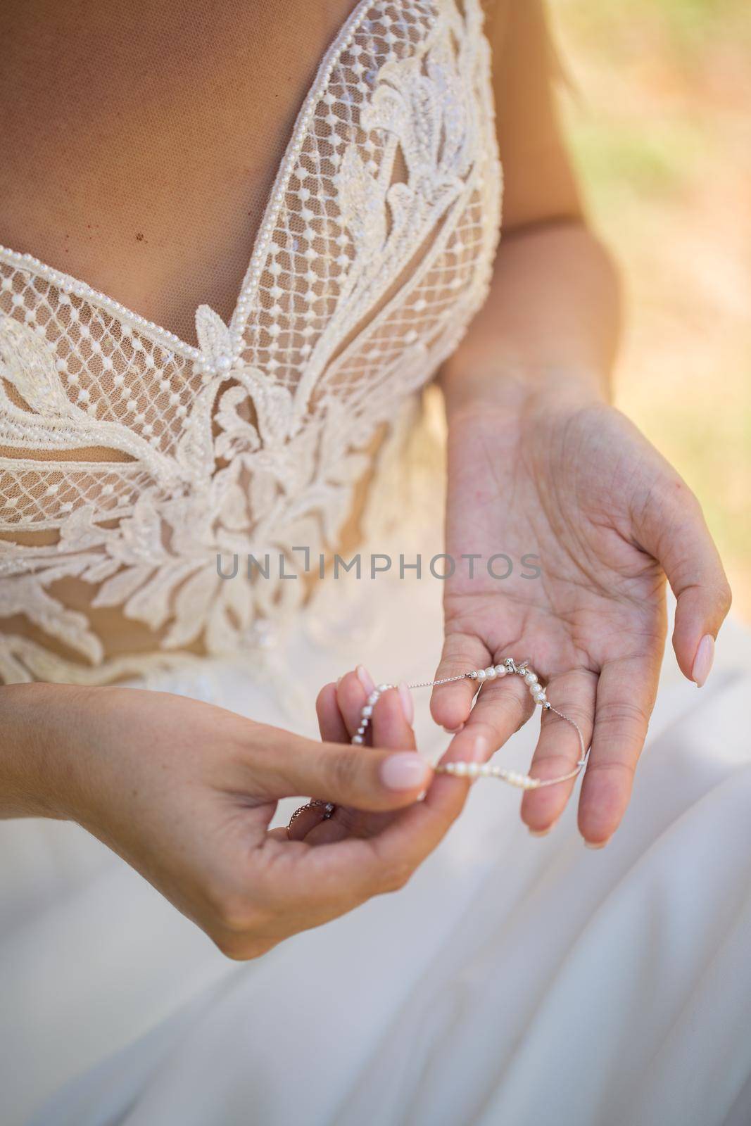 The bride holds a foot ornament in her hands