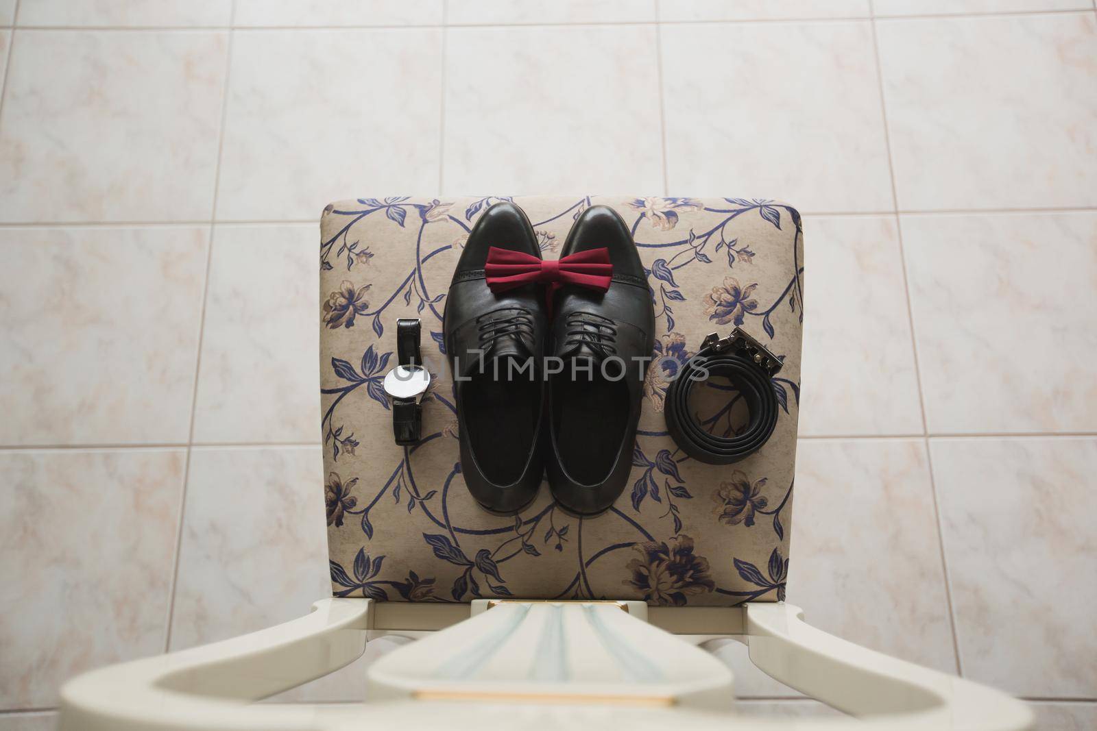 men's shoes with butterfly tie on a chair