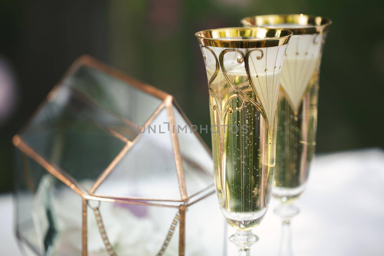 Wedding glasses with champagne on the table. by StudioPeace