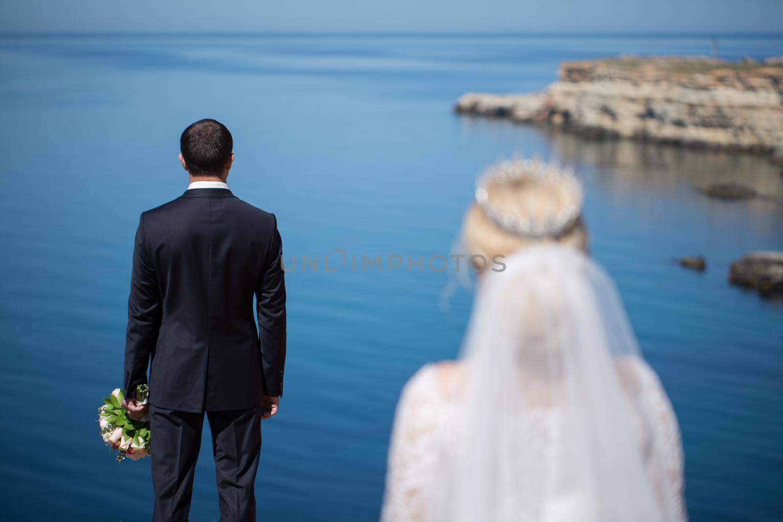 meeting of the bride and groom on a cliff. by StudioPeace