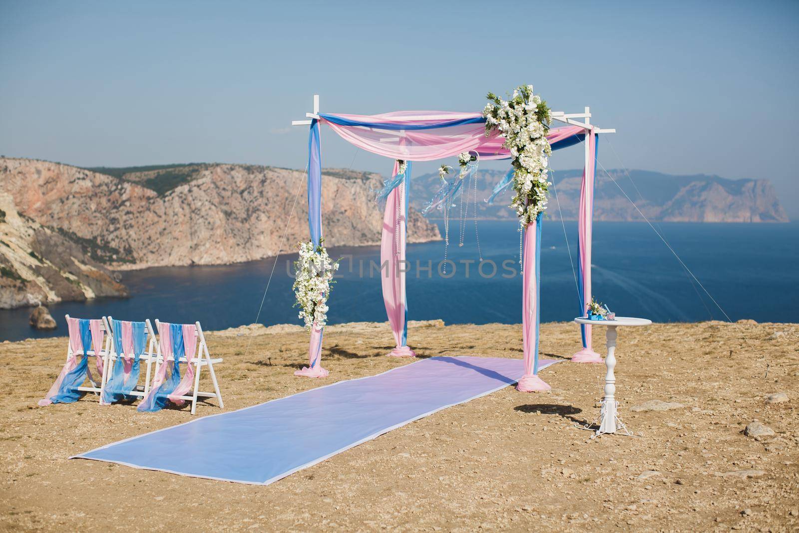 Wedding arch pink color on the background of the sea by StudioPeace