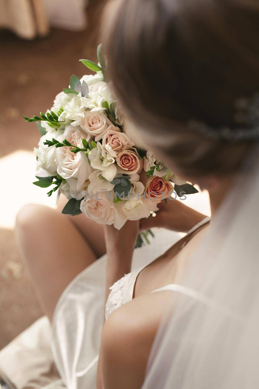 Luxury white wedding bouquet in the hands of the bride.