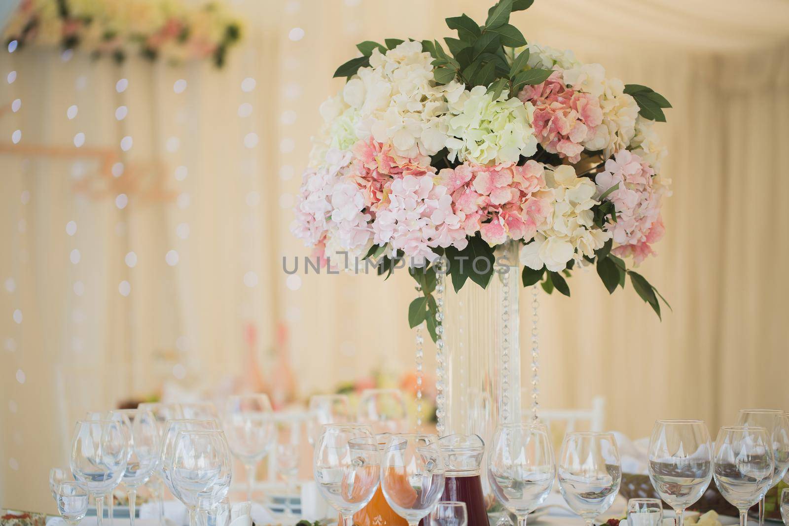 Vases with flowers on the wedding table by StudioPeace