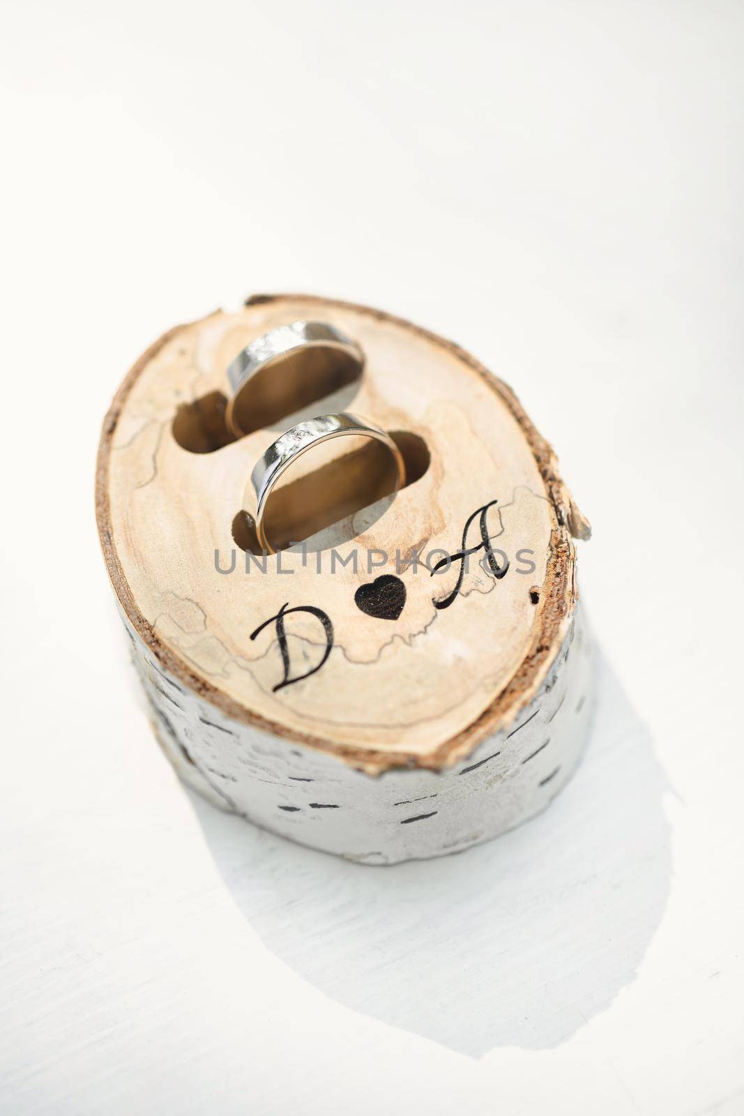 Wedding rings in a box made of birch wood with initials