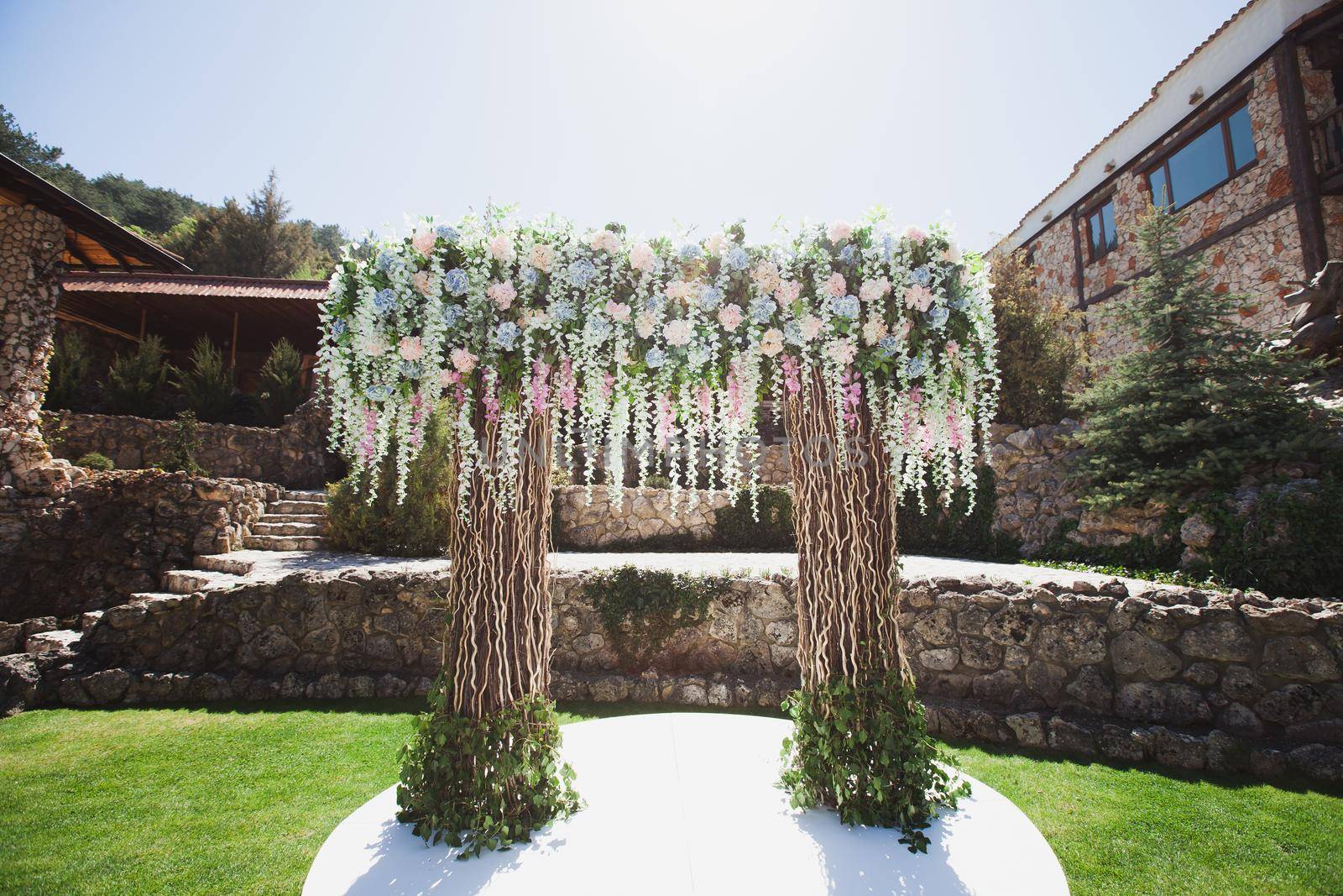 Outdoor wedding ceremony decoration at the hotel. by StudioPeace
