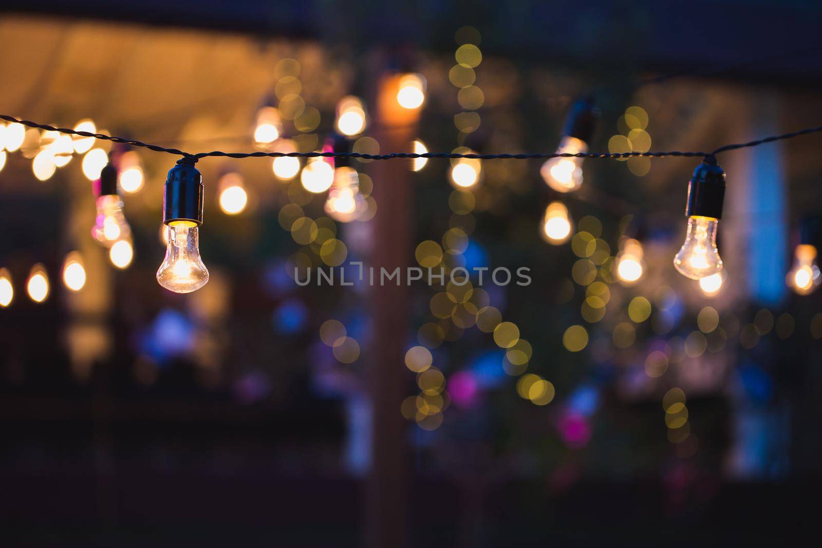 Light bulb decor in outdoor party. Wedding banquet