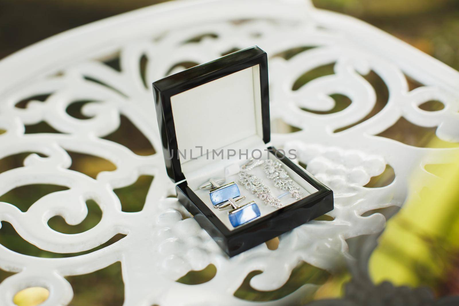 Men's and women's wedding accessories on the table.