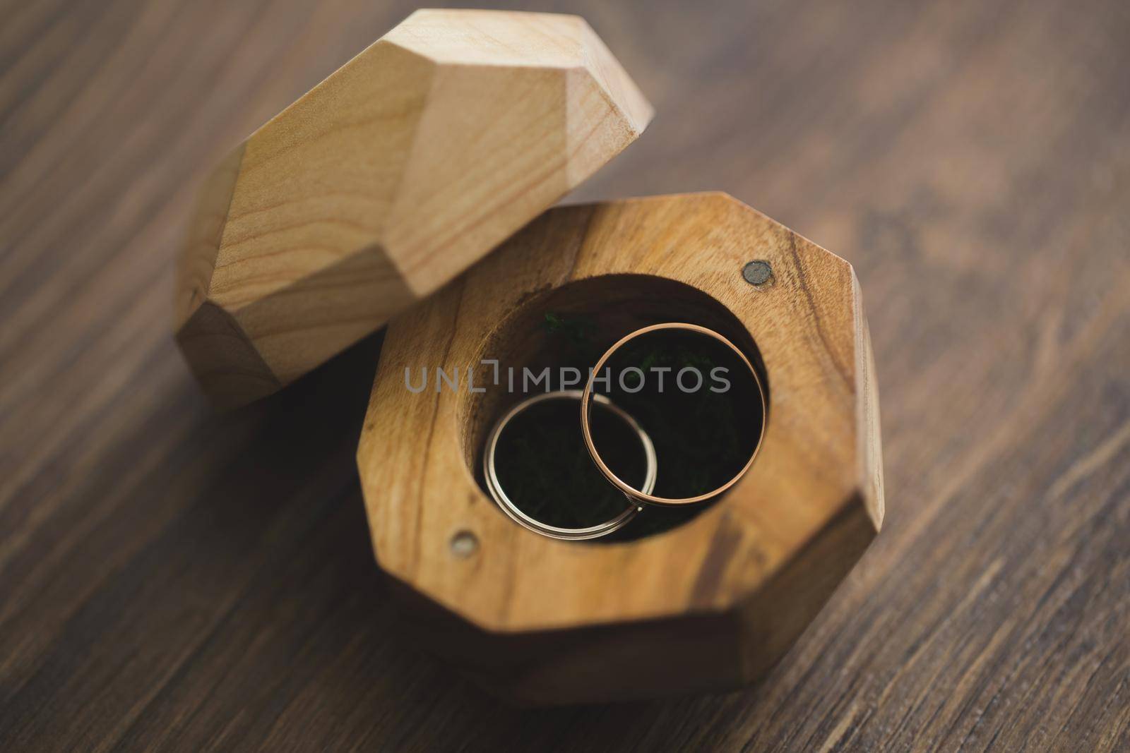 Wedding rings in a wooden box on the table