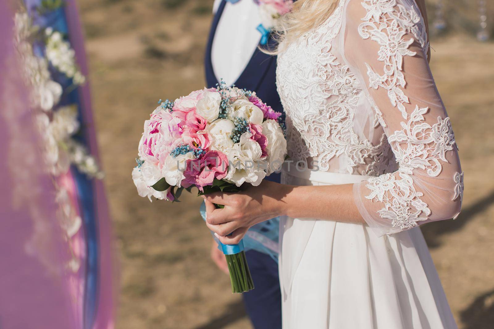 Bride and groom walking together holding their hands.