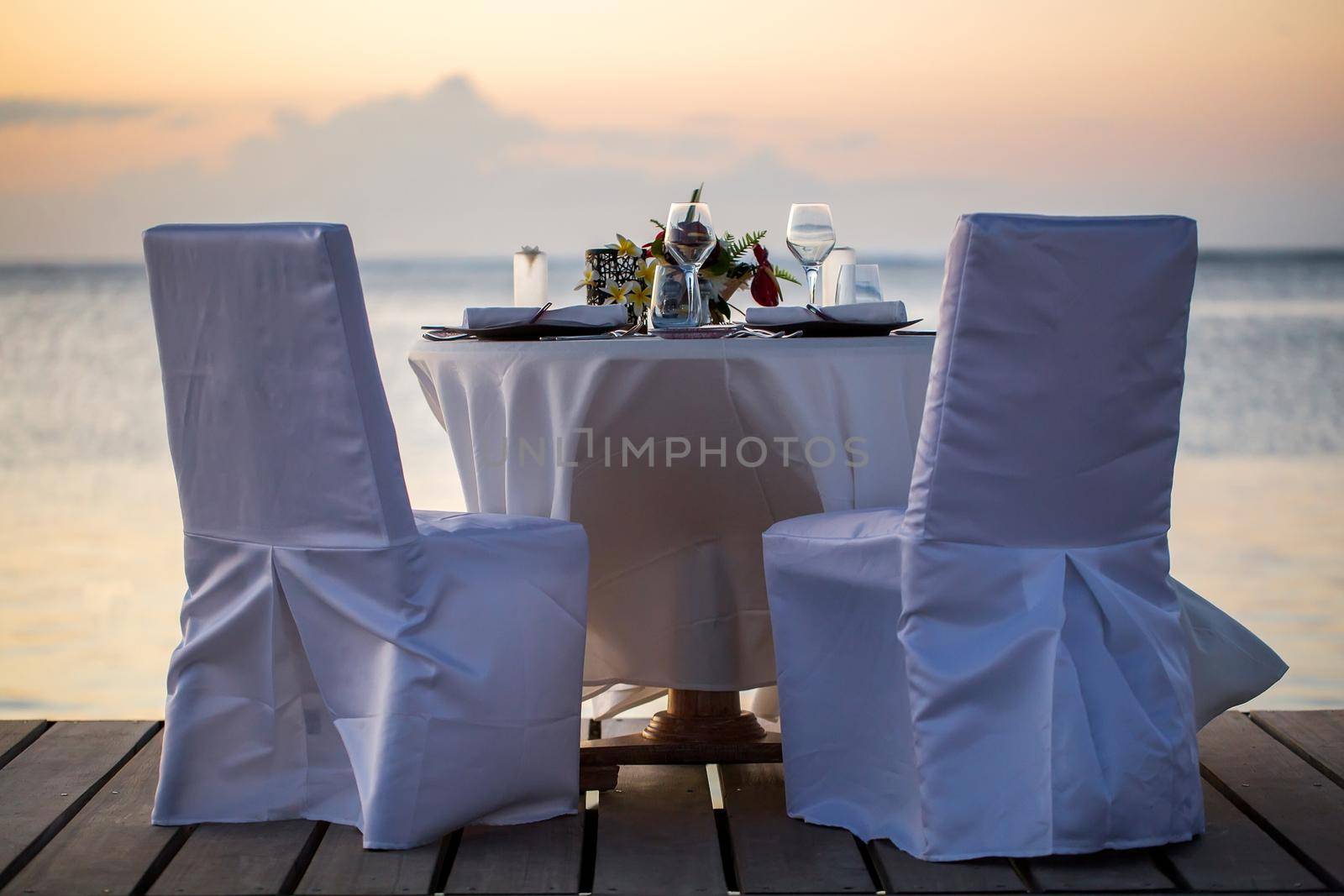 Romantic dinner setting on the beach at sunset. by StudioPeace