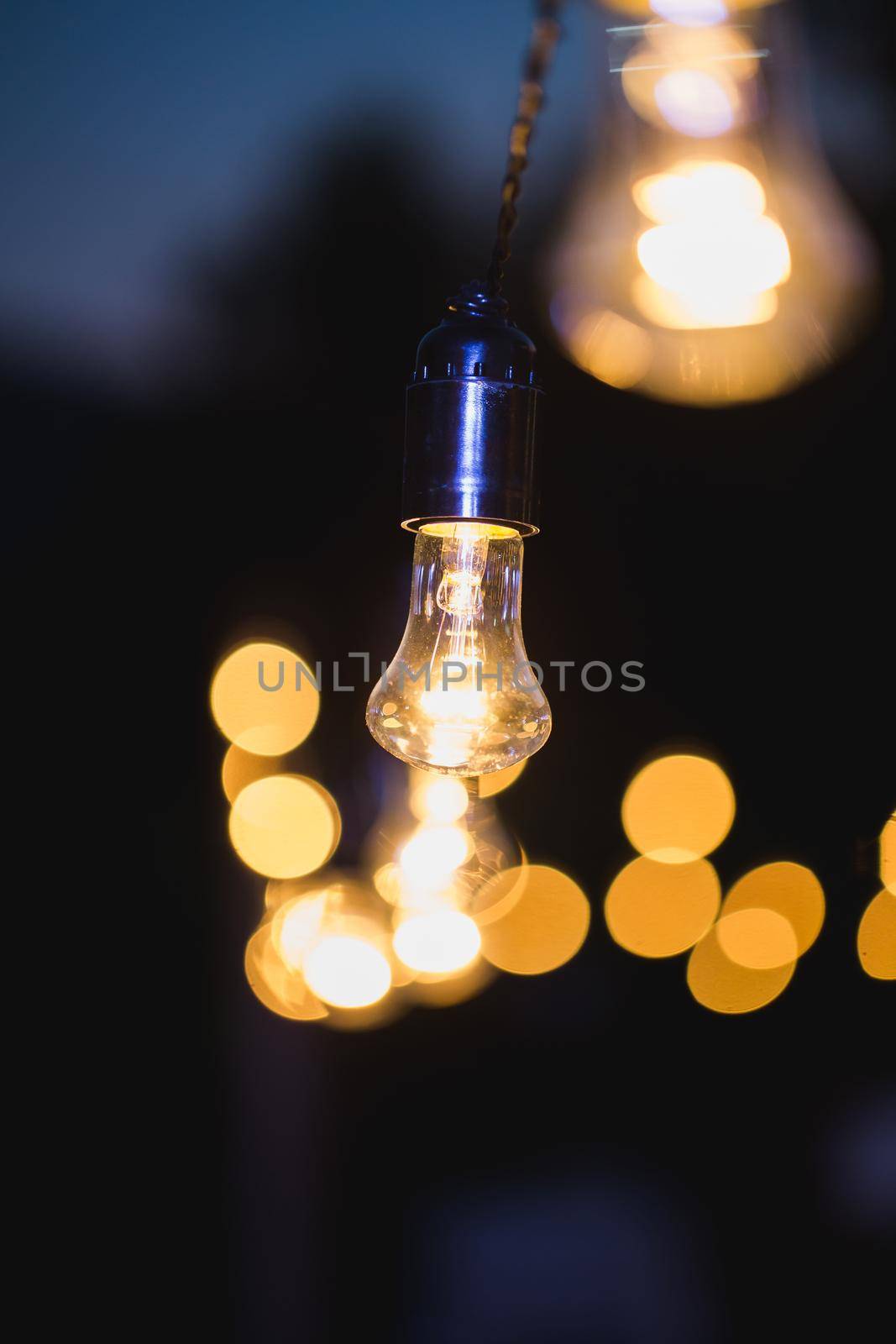 Light bulb decor in outdoor party. Evening wedding ceremony