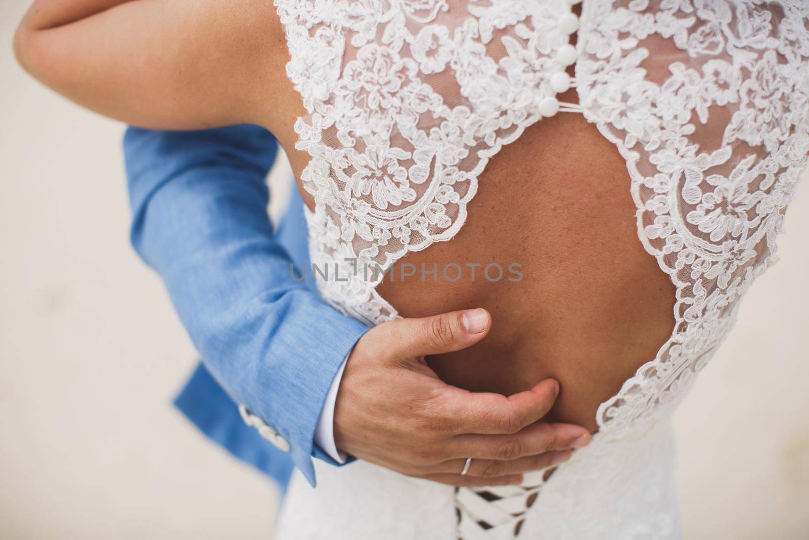 Happy bride and groom on their wedding hugging. by StudioPeace