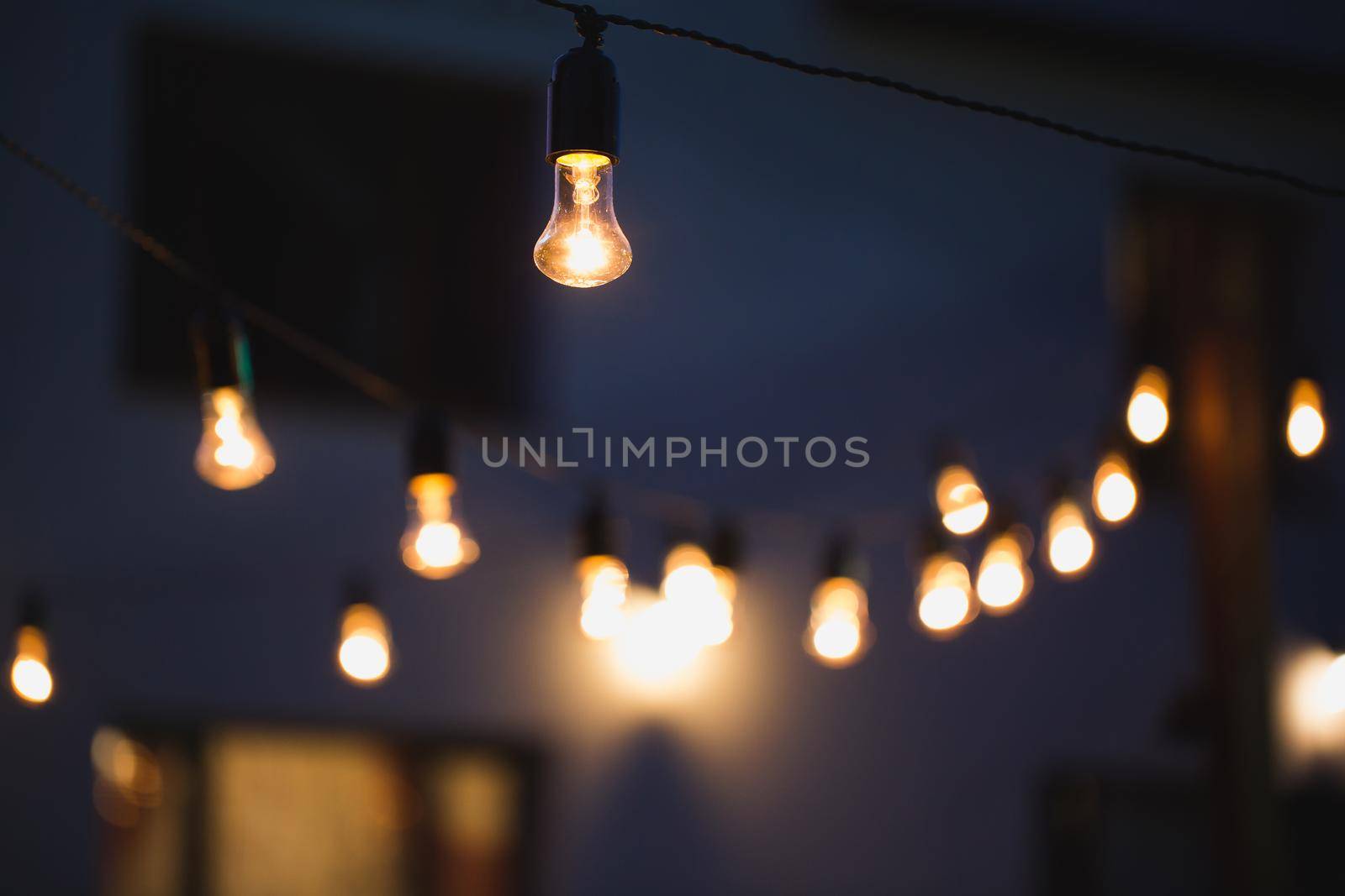 outdoor string lights hanging on a line in backyard