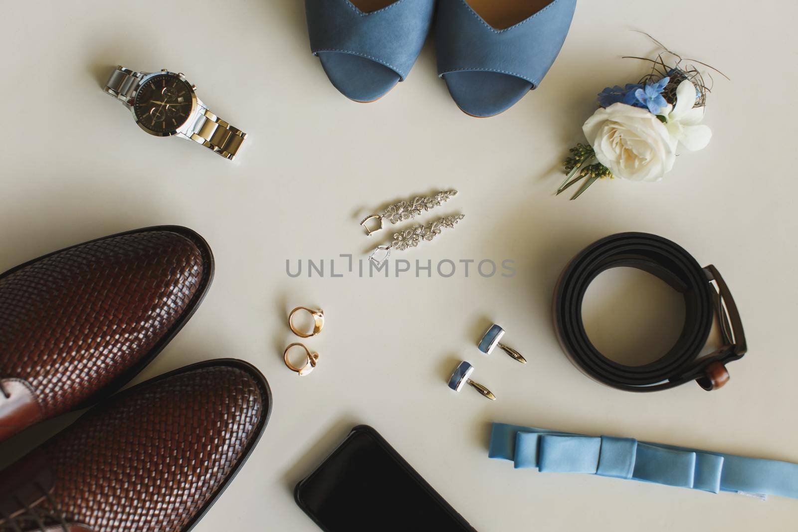Men's and women's wedding accessories on the table.