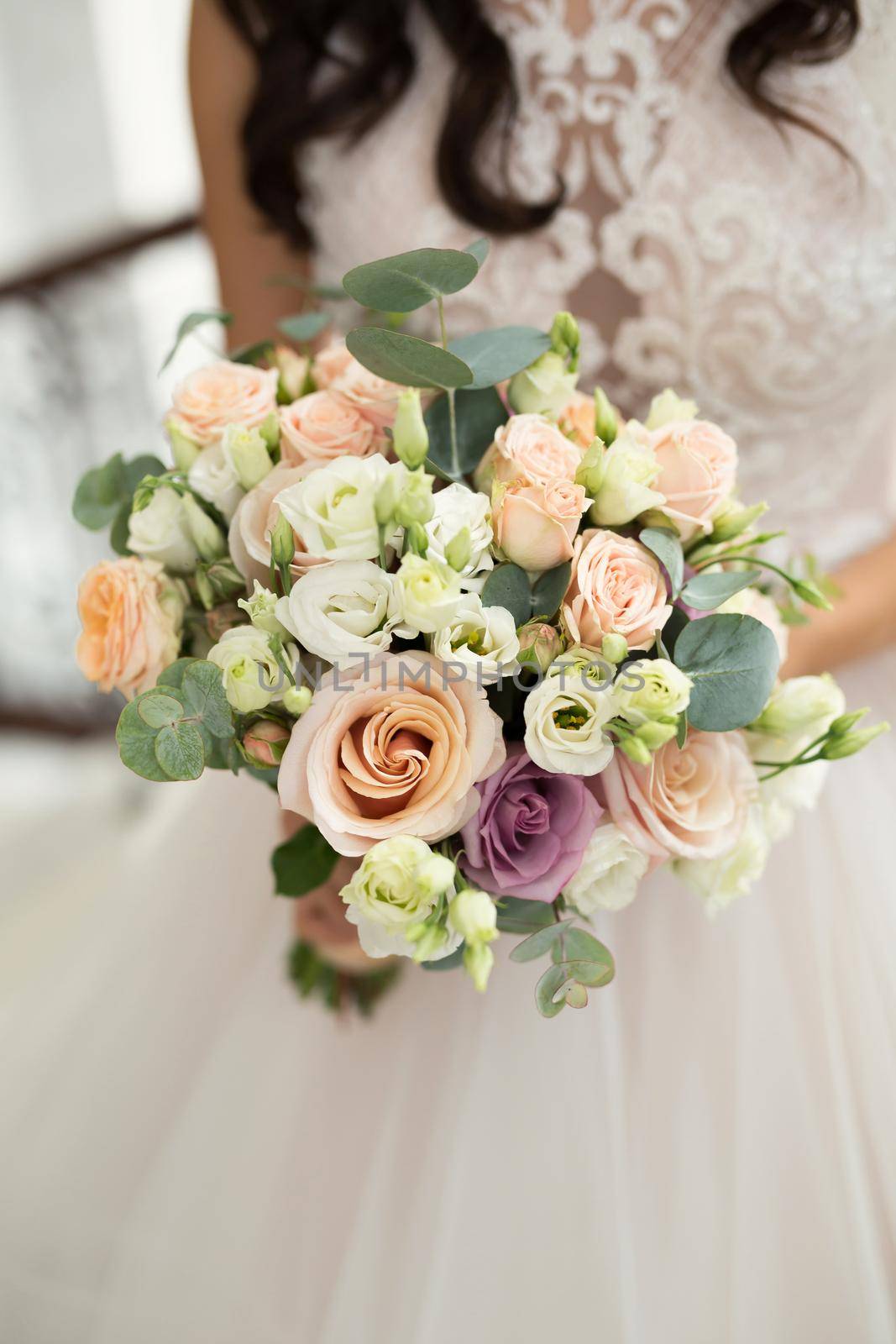 Close-up of a bouquet of flowers in the hands of the bride.