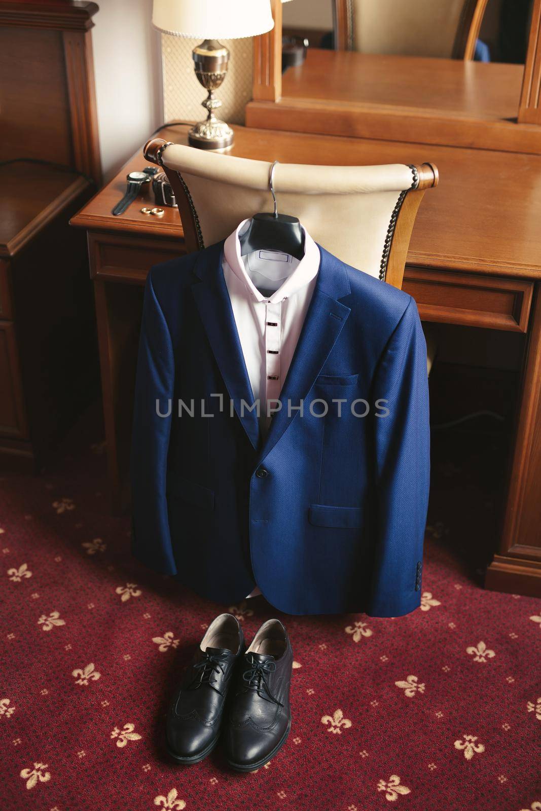 Blue men's suit and black groom 's shoes