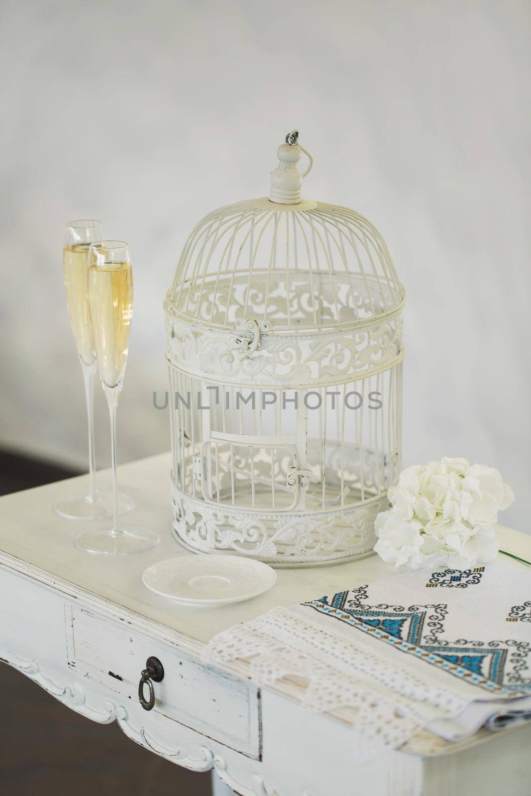Wedding accessories: champagne glasses, cage, wedding towel by StudioPeace