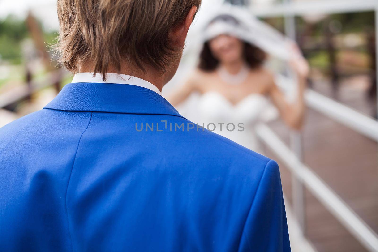 The first meeting of the bride and groom on the wedding day. Emotions newlyweds before the wedding ceremony. Bride and groom look at each other by StudioPeace