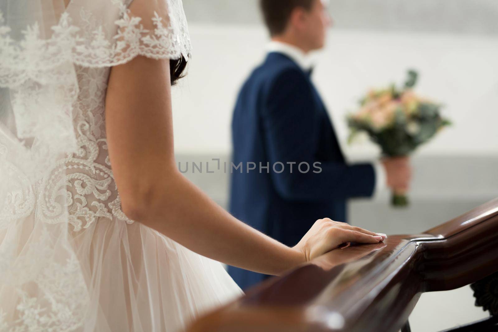 The bride goes to meet the groom. hand on a wooden railing close up