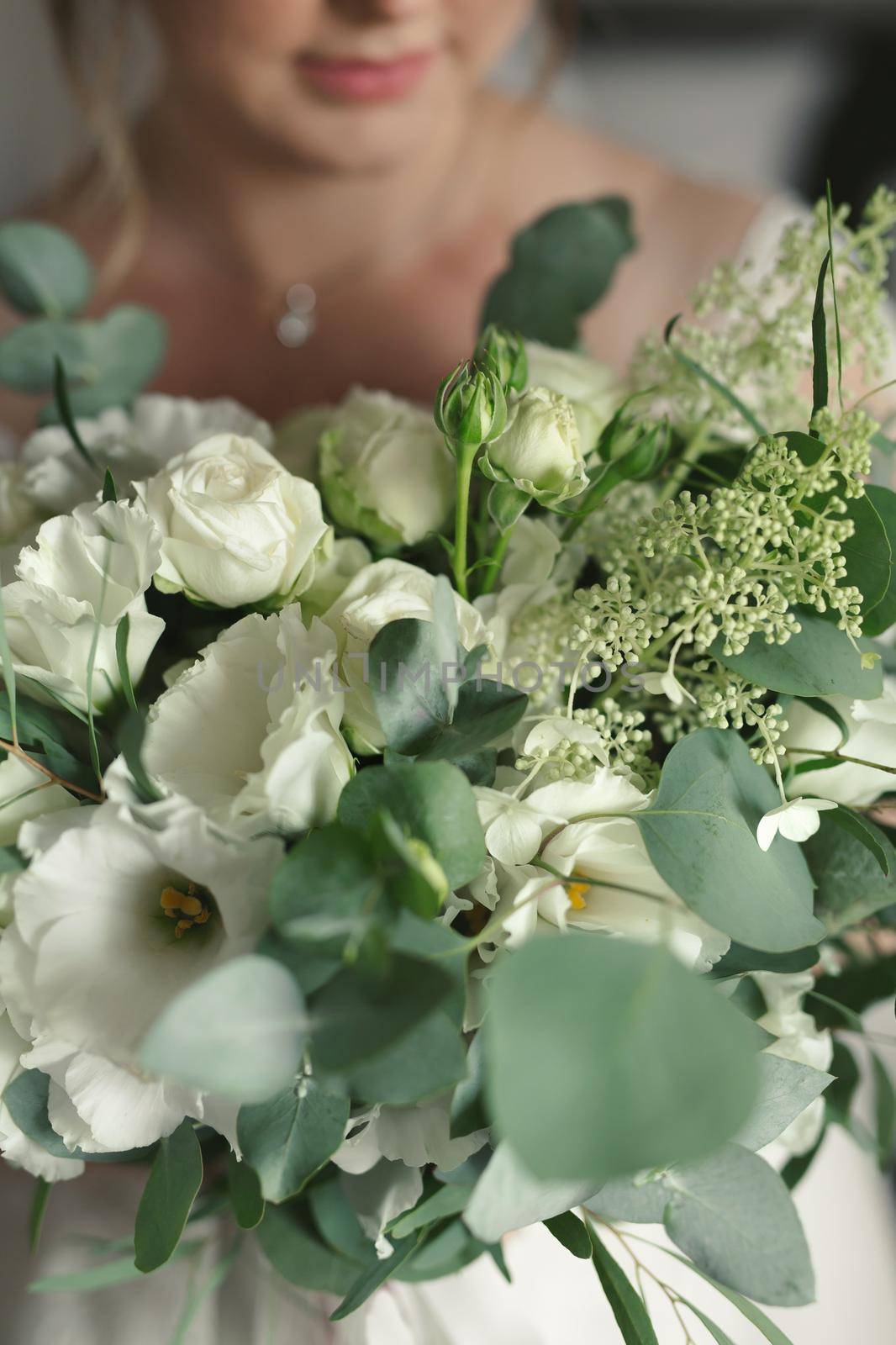 Close-up of a bouquet of flowers in the hands of the bride.