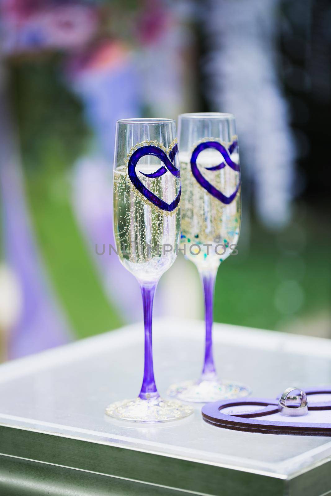Wedding glasses with champagne on the table. by StudioPeace
