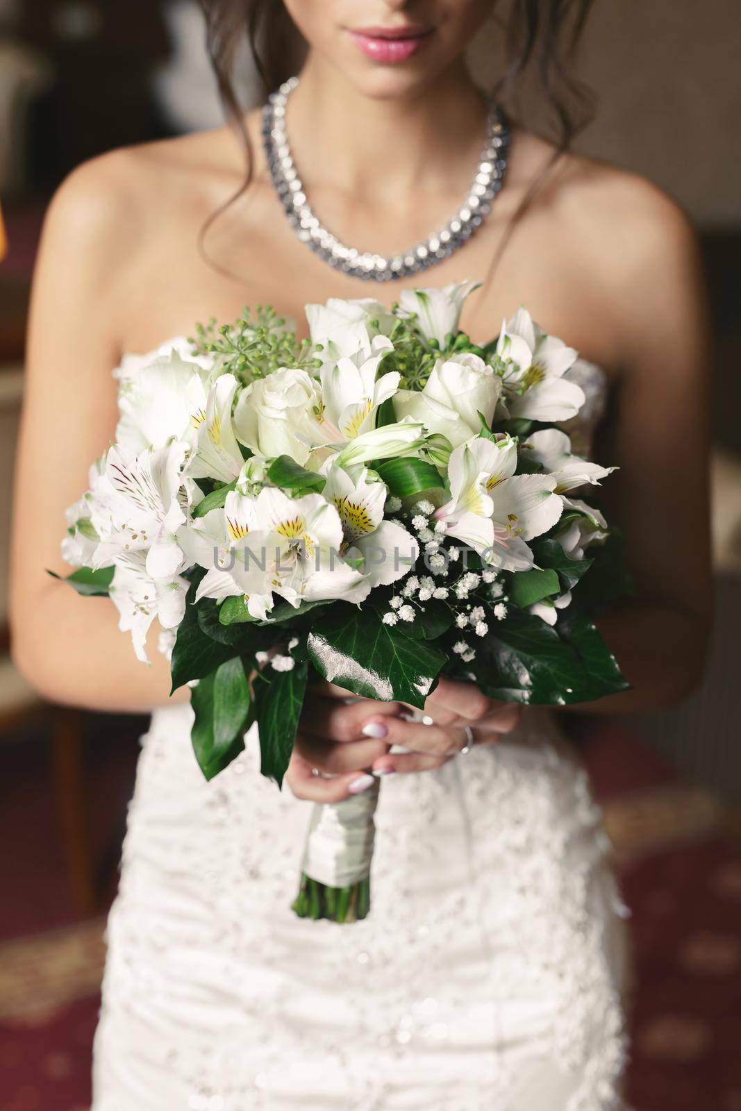 Close-up of a bouquet of flowers in the hands of the bride.