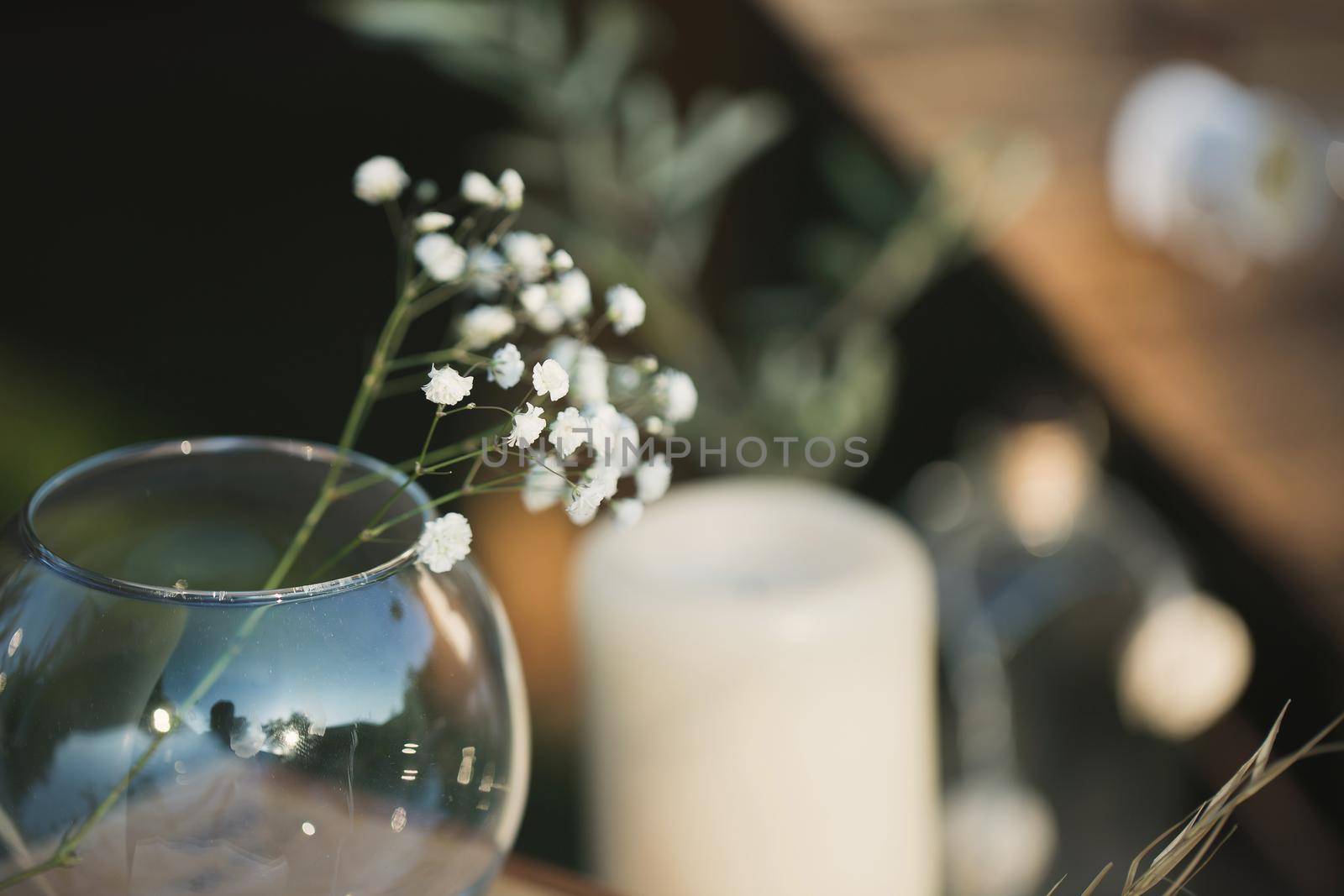 Wedding decor made of candles, wooden boxes and gypsophila