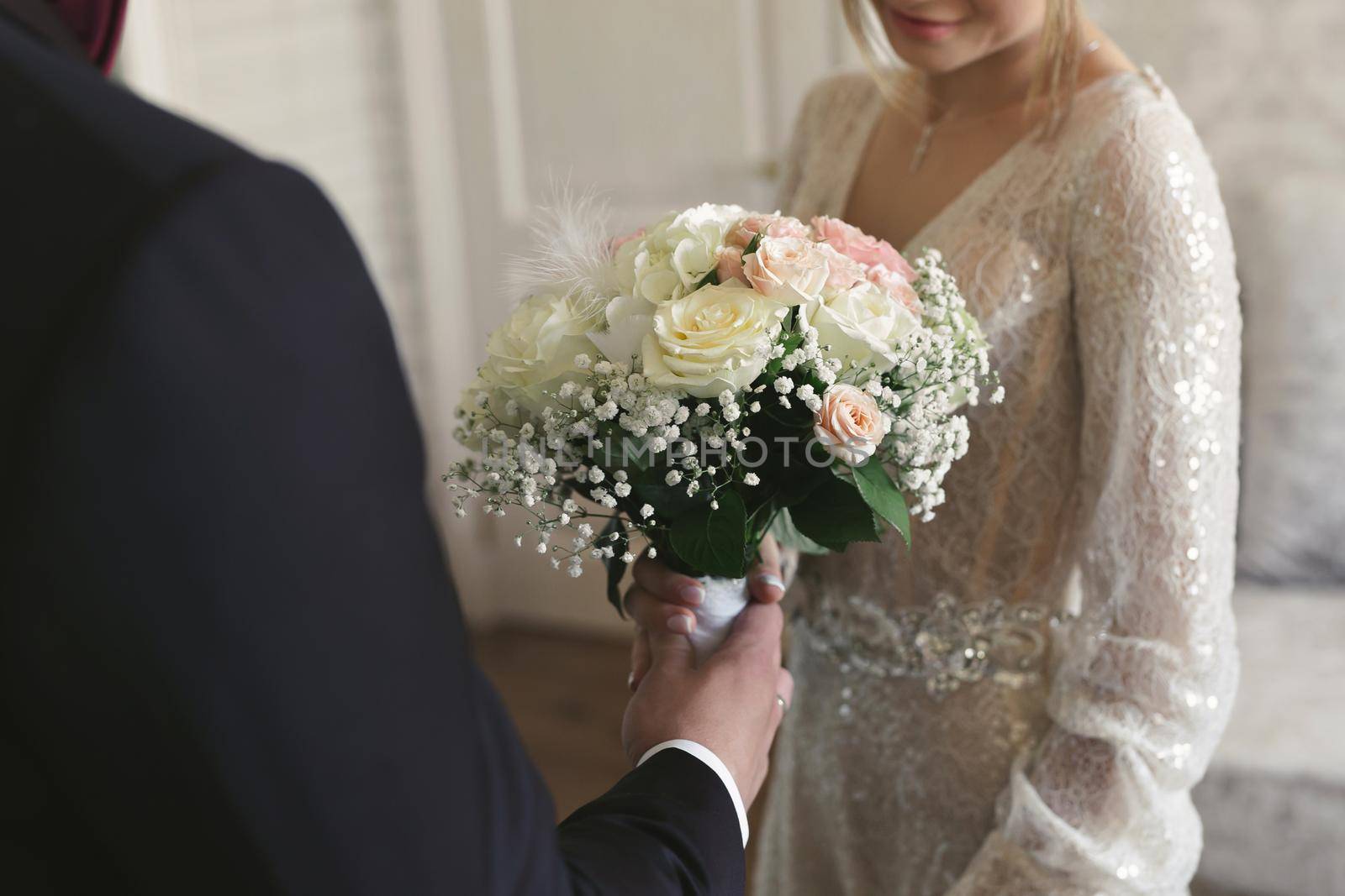 Groom gives the bride a bouquet of beautiful flowers.