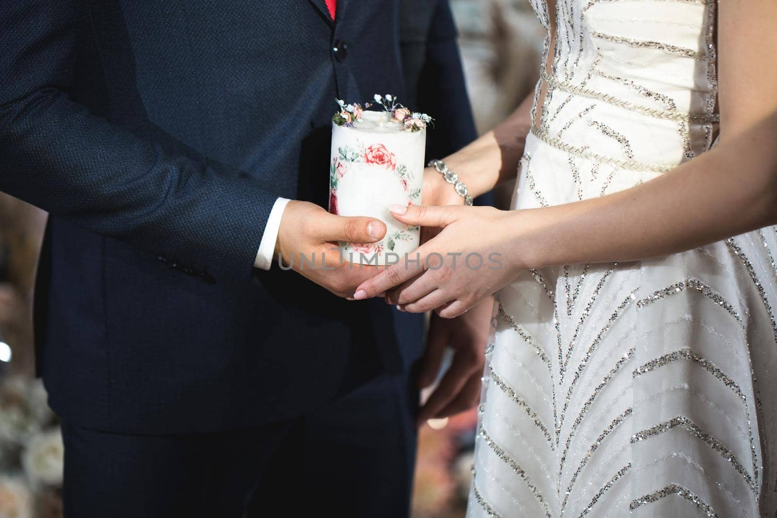 Wedding ceremony, paraphernalia, the bride and groom hold a large candle in their hand