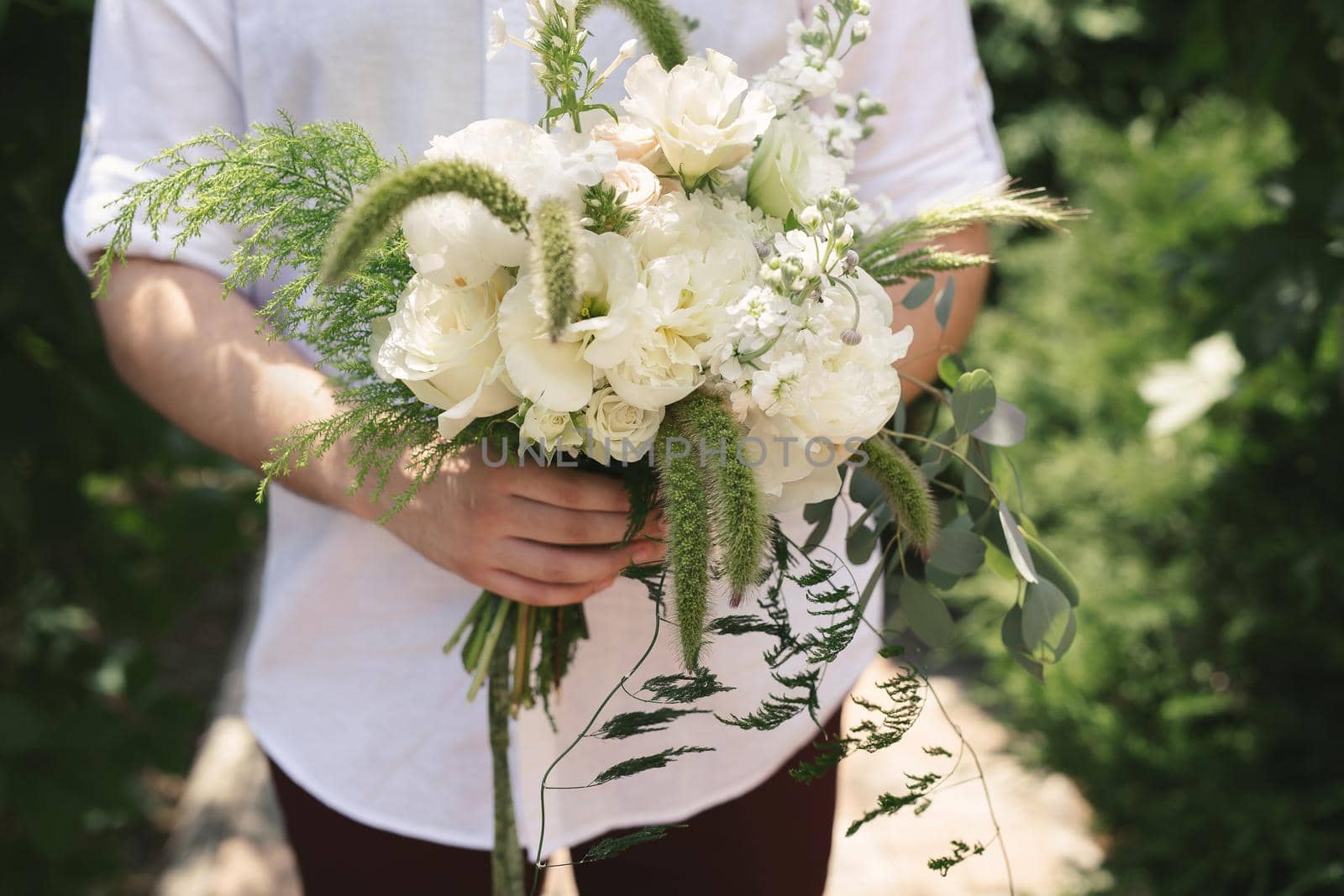 Beautiful bouquet of white and green flowers in the hands of the groom by StudioPeace