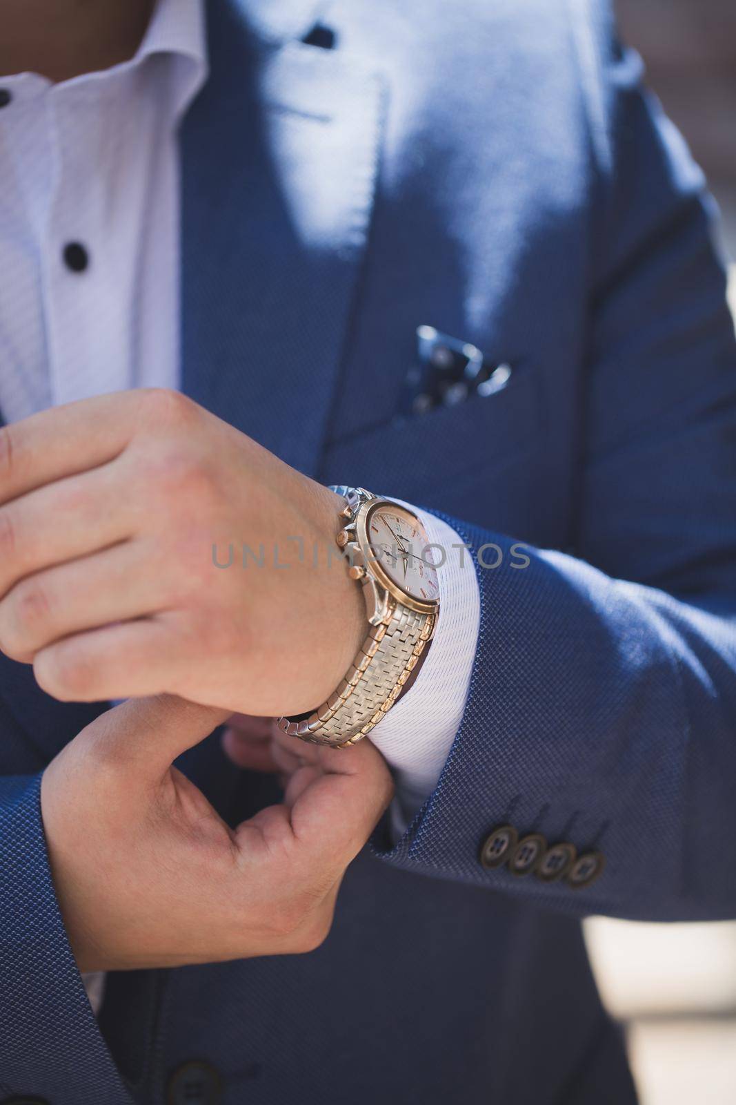 Businessman looking at his watch. Man hands and clock. by StudioPeace