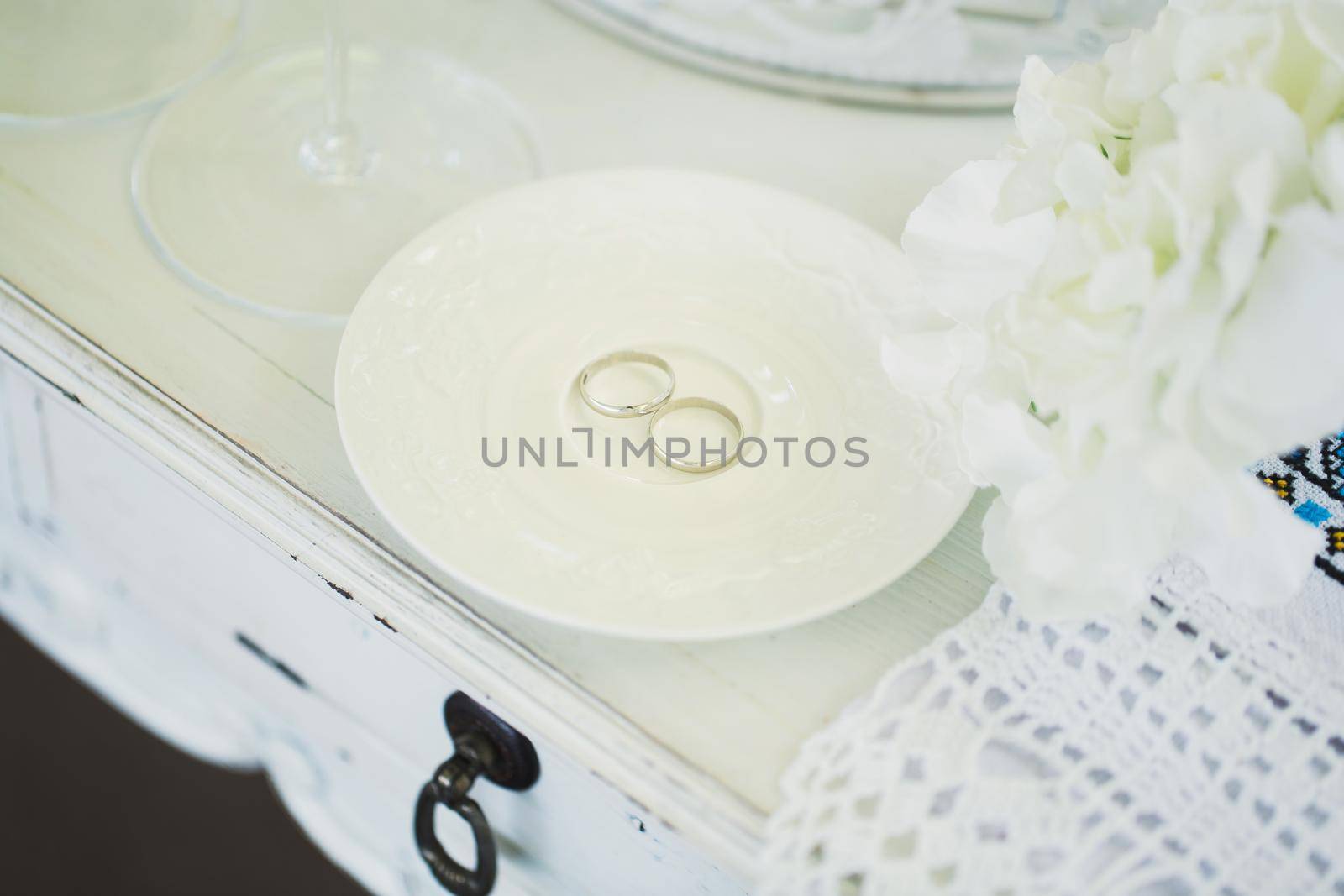 Wedding rings on a ceramic white saucer