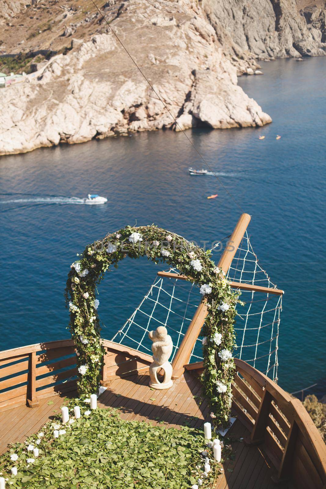 Luxurious wedding ceremony on a ship with a view of the sea and mountains.