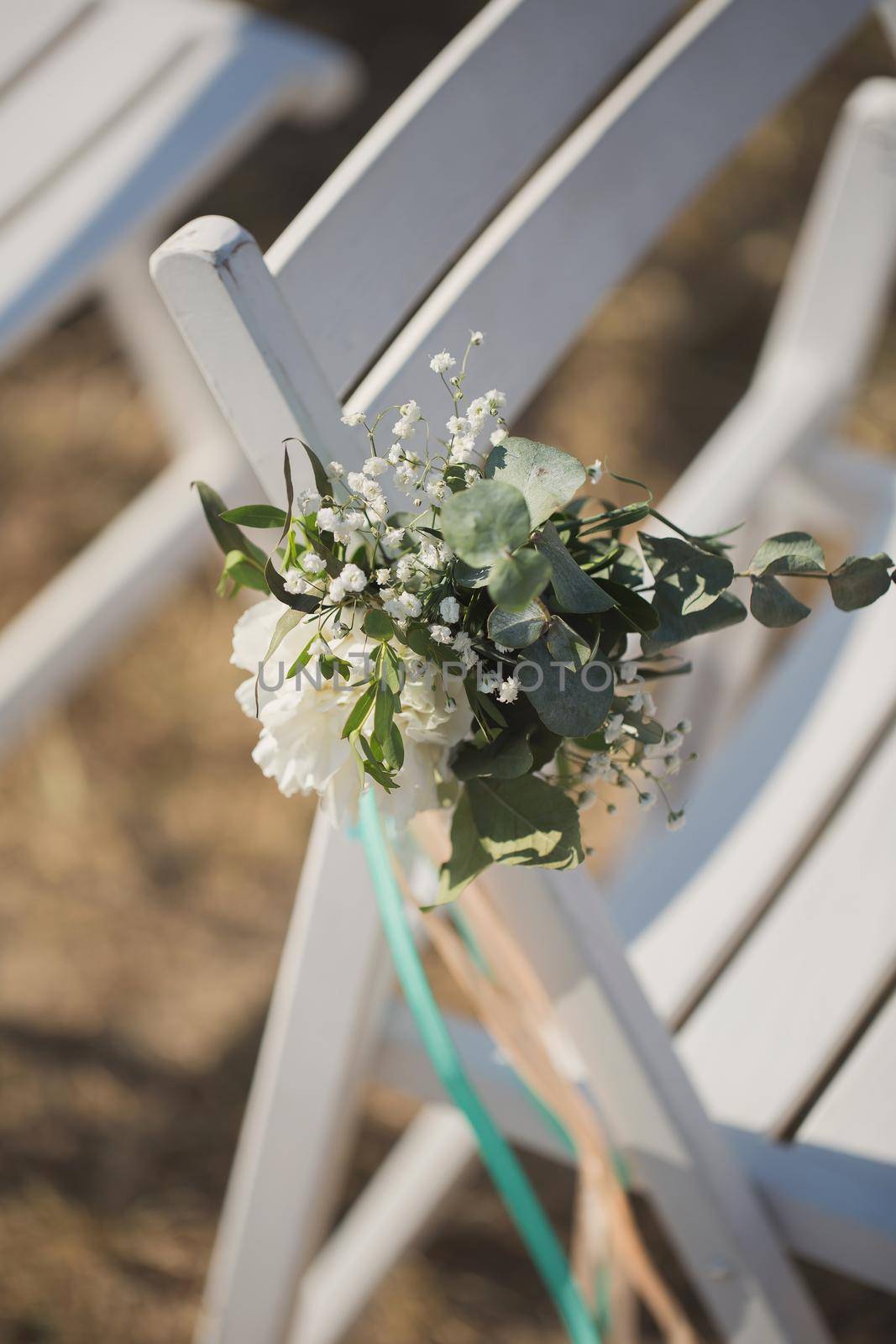 Close up of flower decorated on wedding chair. by StudioPeace