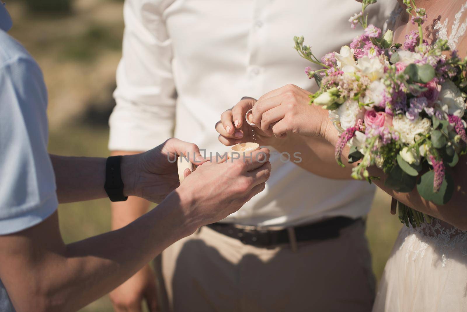 Bride and groom take the rings at the wedding ceremony.