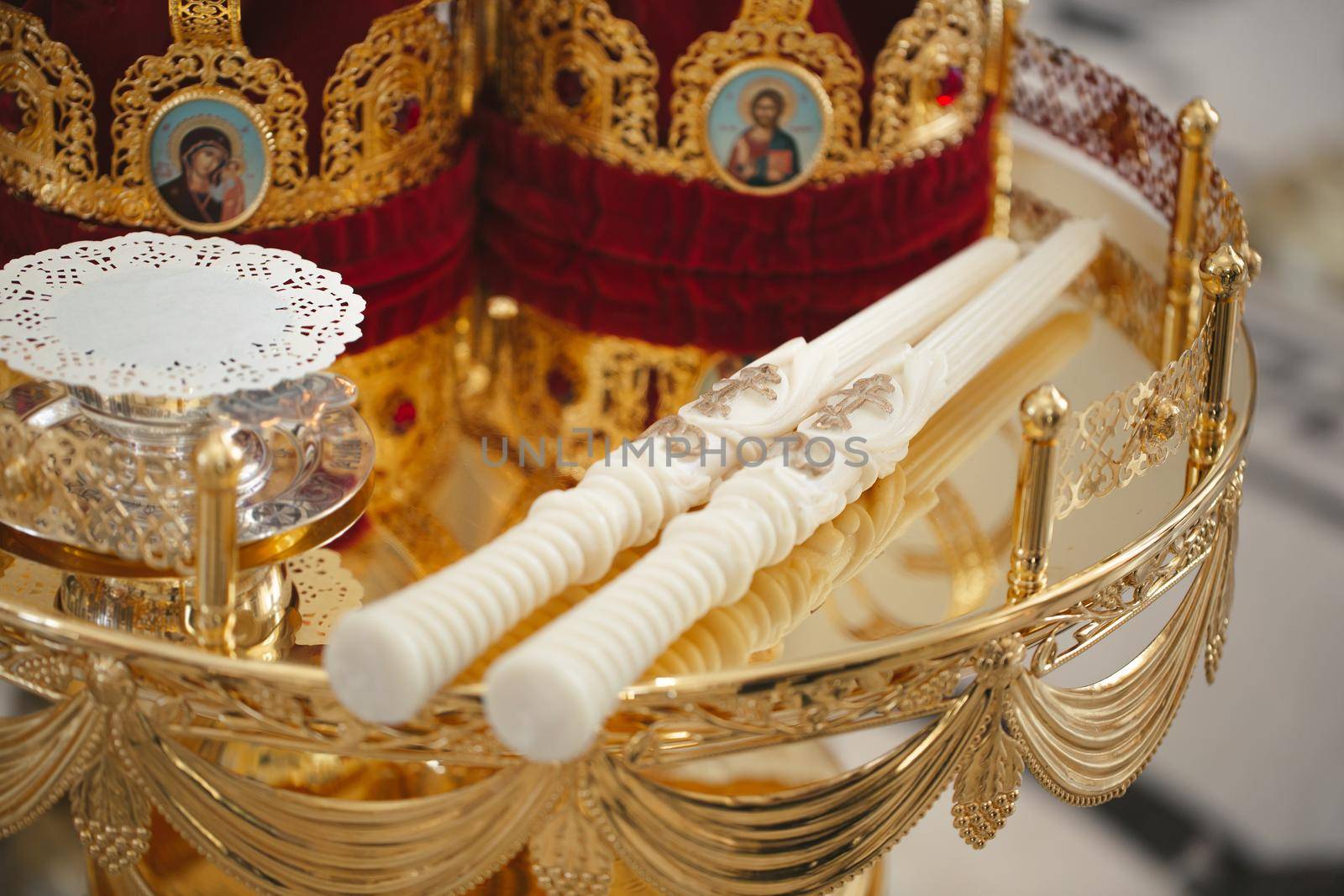 Close-up of candles in the church before the wedding ceremony by StudioPeace