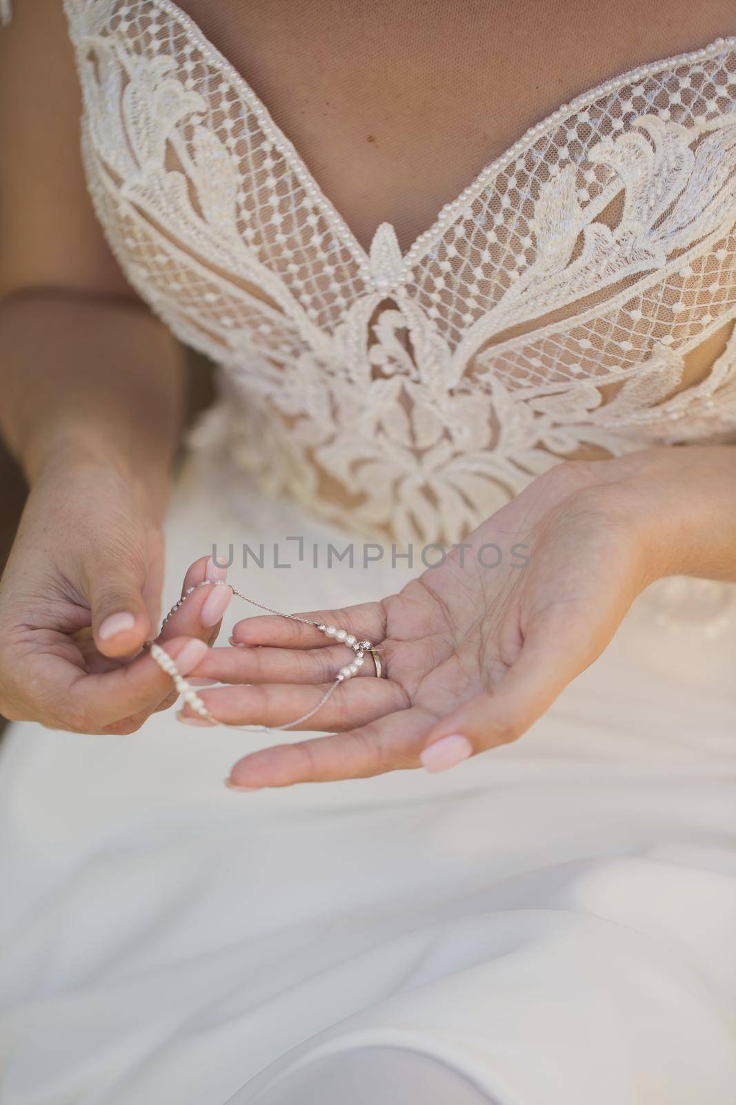 The bride is holding an ornament in her hands.