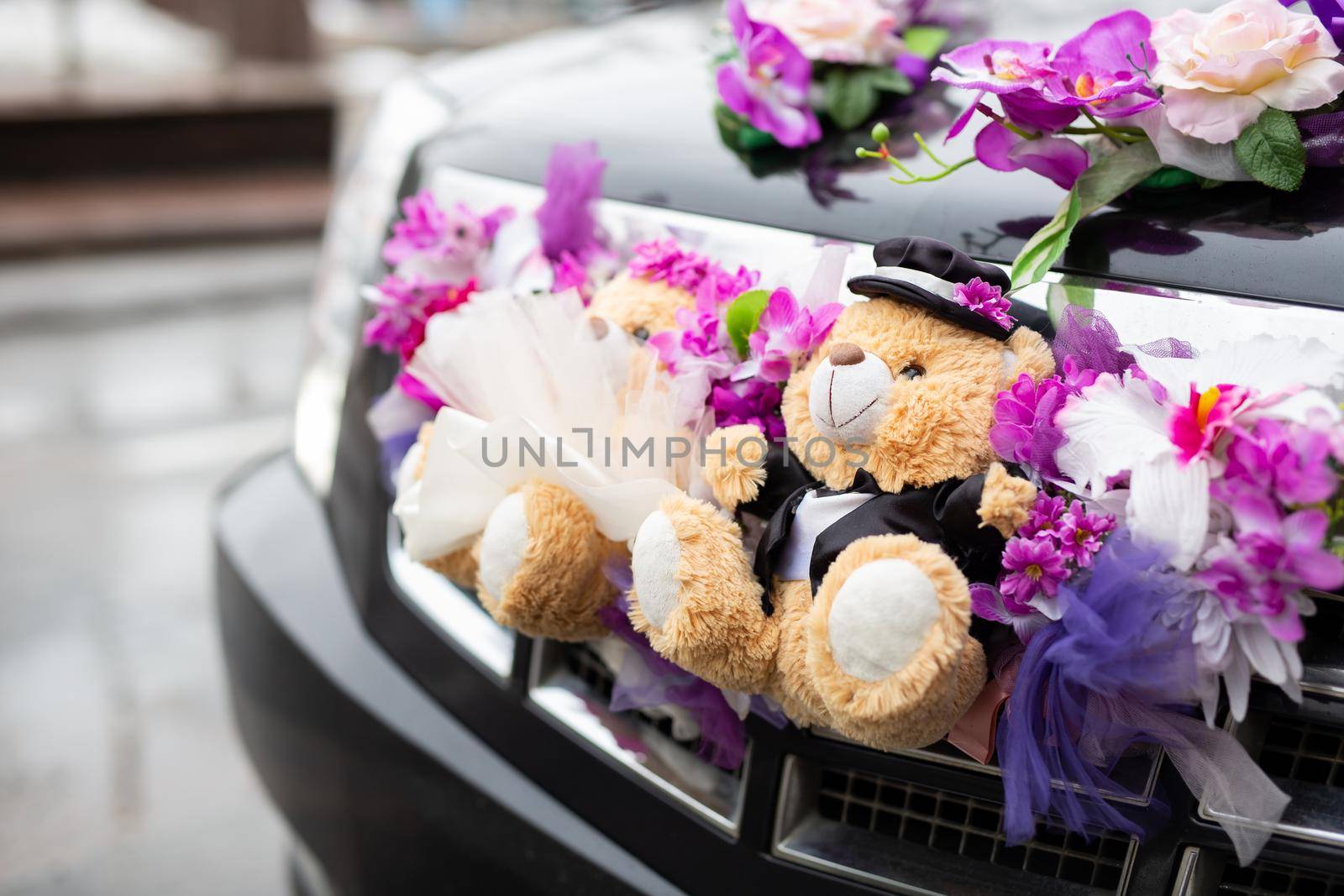 Cute couple teddy bear in dress suit decorated on wedding car. by StudioPeace