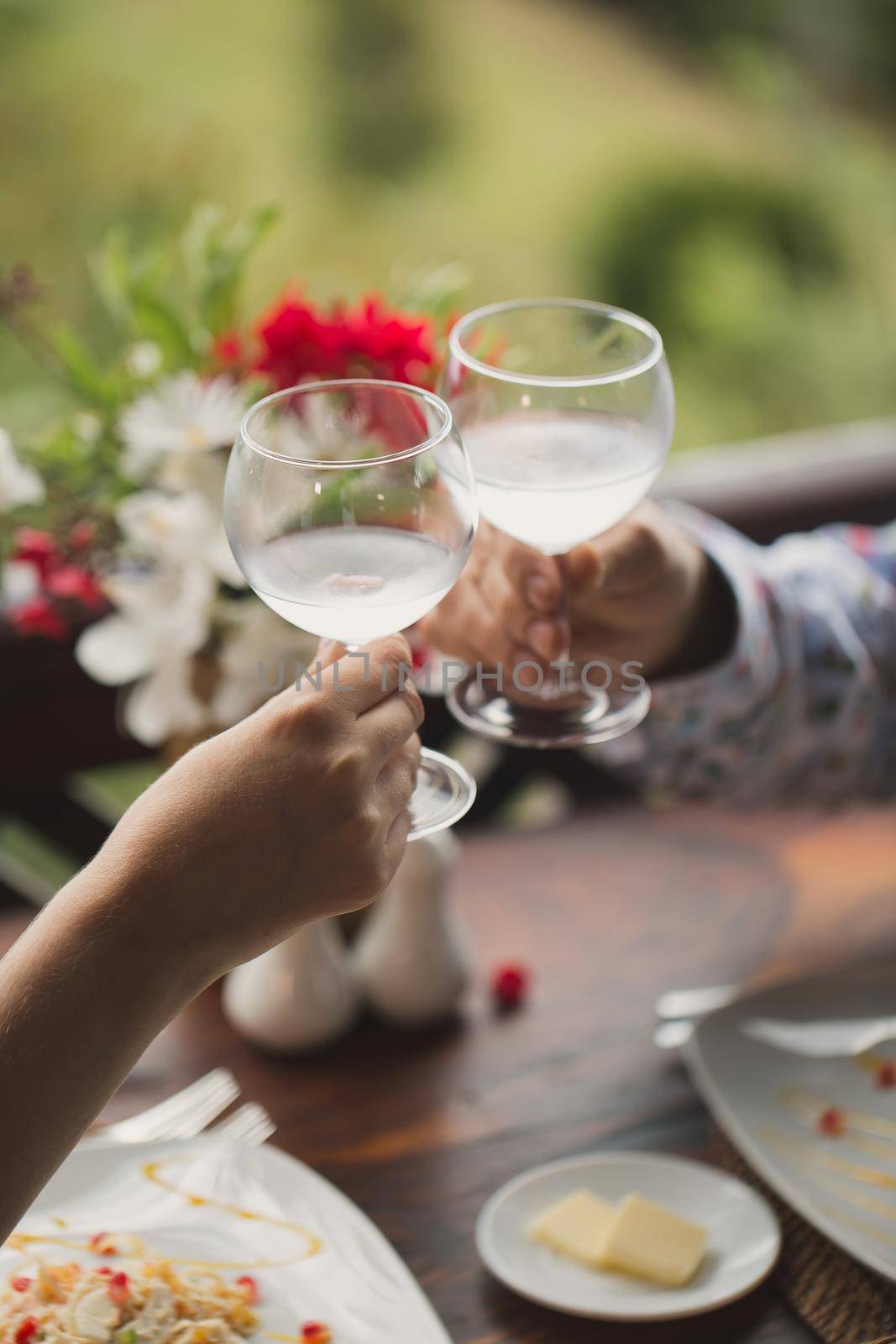 bride and groom holding beautifully decorated wedding glasses. by StudioPeace