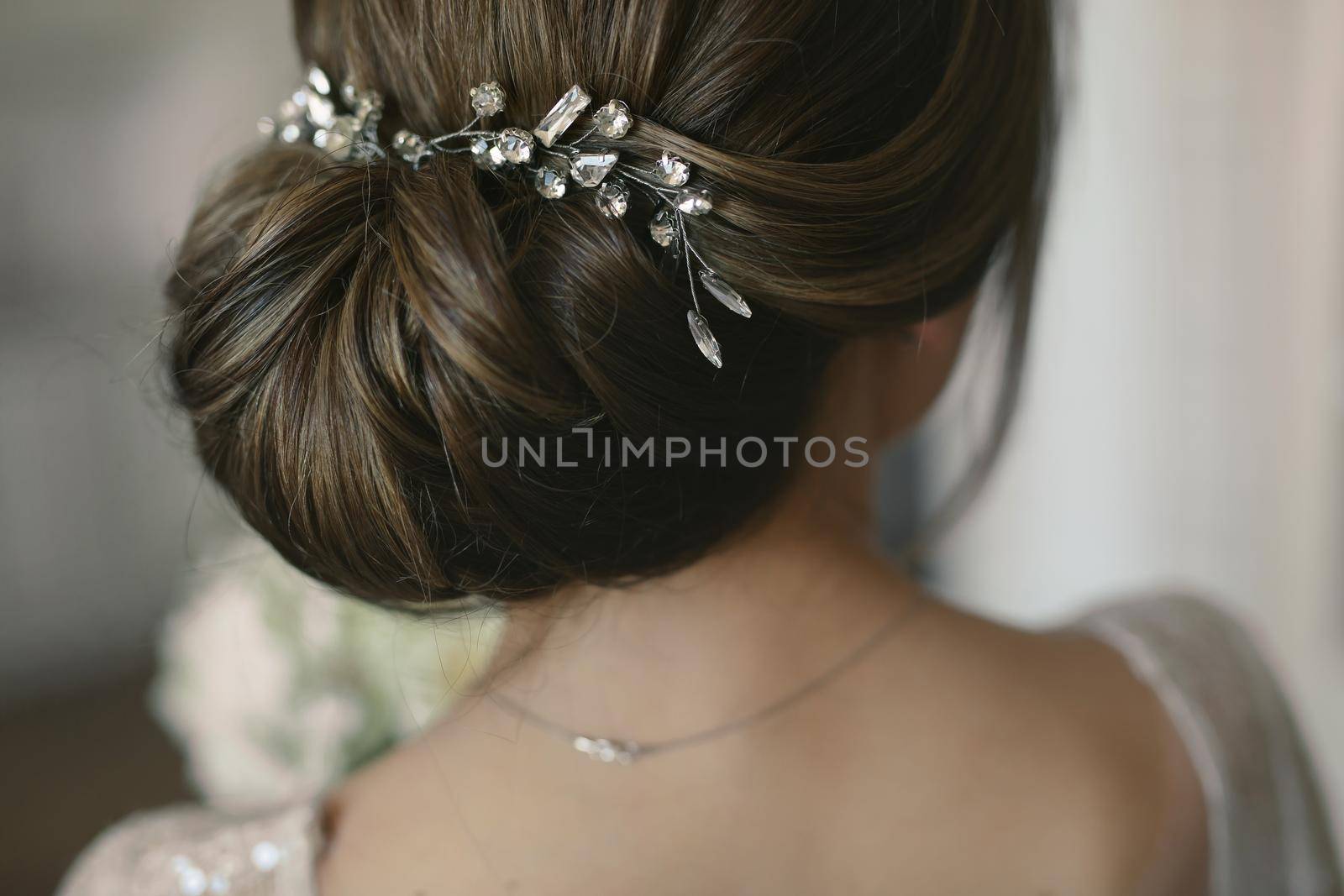 Wedding hairstyle of the bride. Rear view