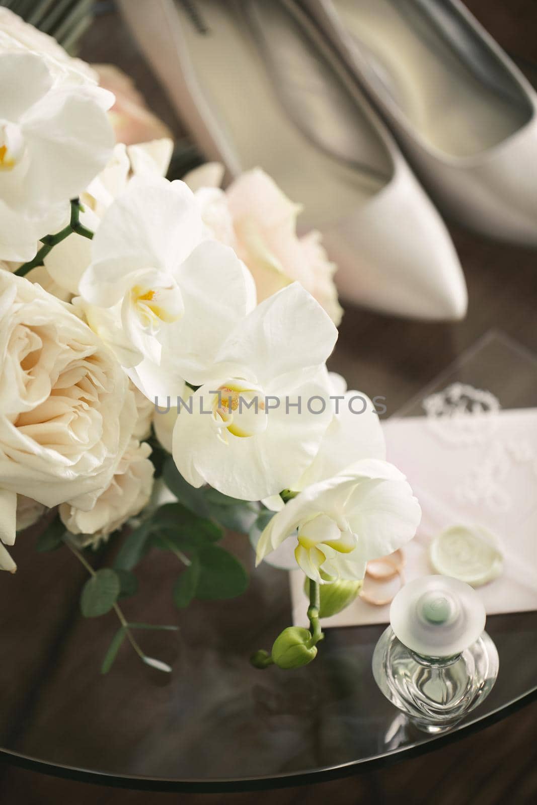 Elegant bouquet of roses and orchids, shoes and accessories of the bride close-up by StudioPeace
