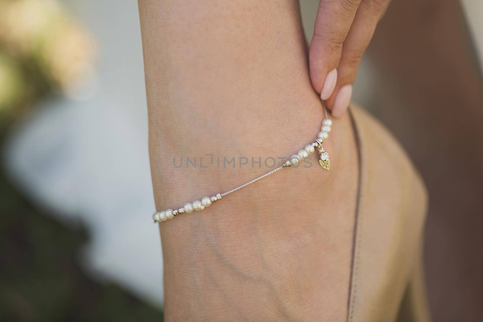 Elegant jewelry with pearls on the bride's leg by StudioPeace