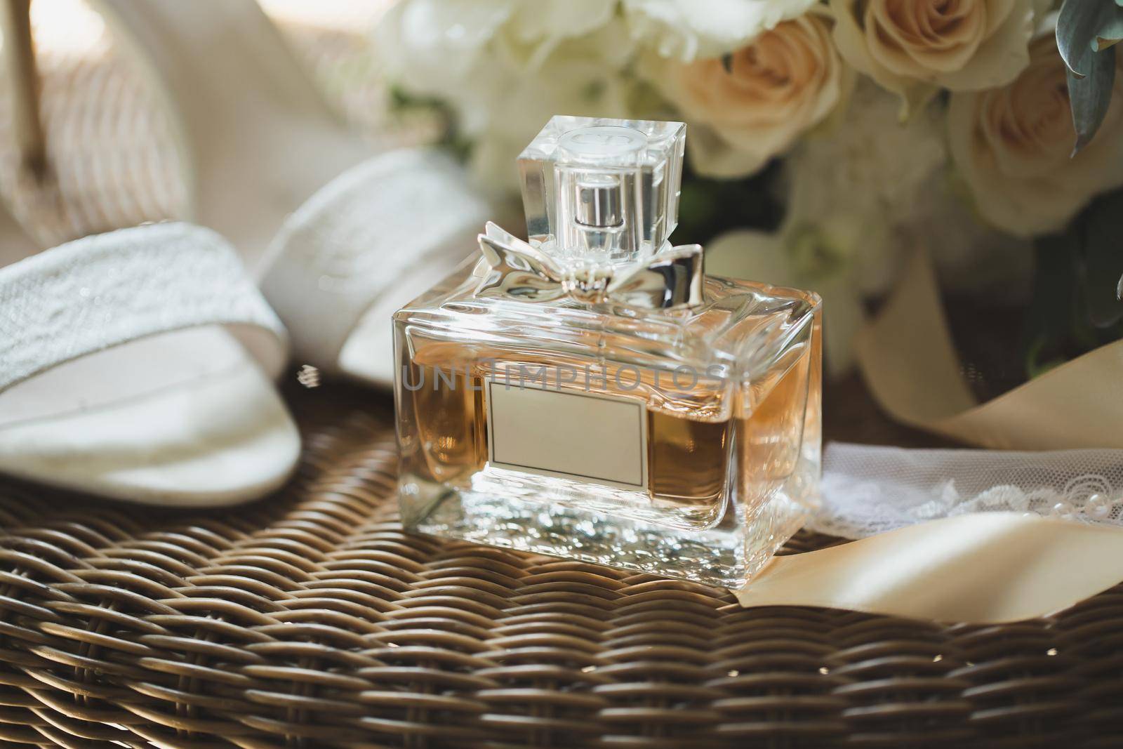 Wedding shoes with bouquet of flowers and perfume